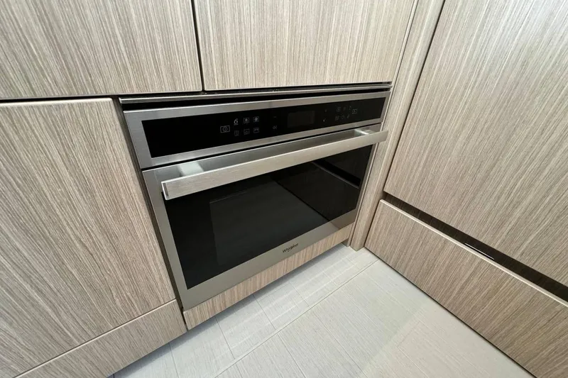  Yacht Photos Pics Modern Prestige F4.9 oven, 2026 model, integrated in sleek wooden cabinetry.