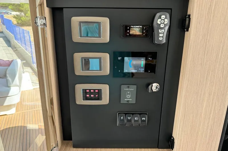  Yacht Photos Pics Control panel of a 2026 Prestige F4.9 yacht with various digital displays and switches.