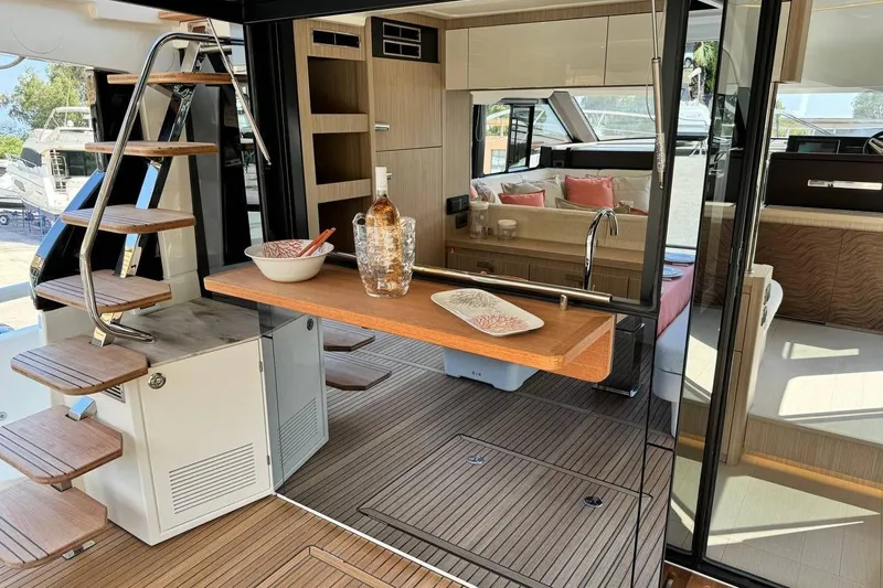  Yacht Photos Pics Luxurious interior of 2026 Prestige F4.9 yacht with modern kitchen and elegant seating area.