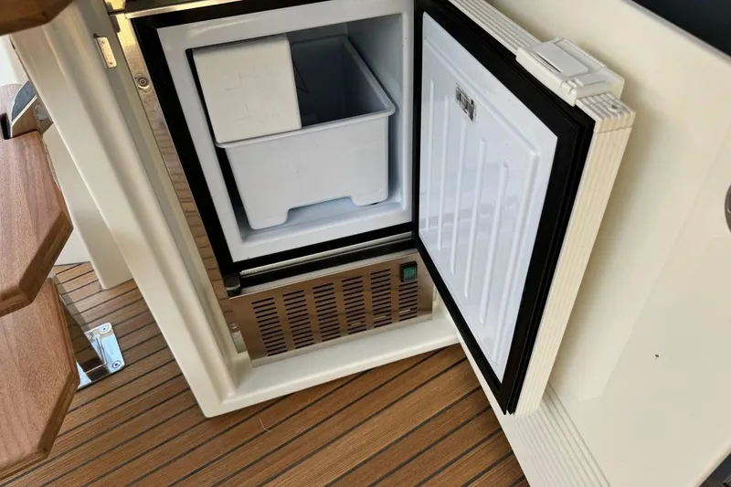  Yacht Photos Pics Open mini fridge on Prestige F4.9 yacht, showcasing interior storage, 2026 model.