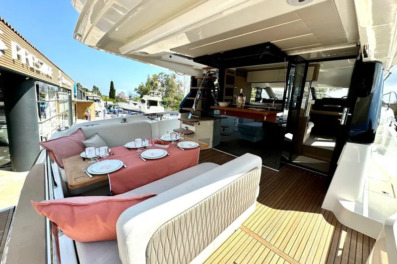  Yacht Photos Pics Luxurious 2026 Prestige F4.9 yacht with elegant outdoor dining area and modern interior design.