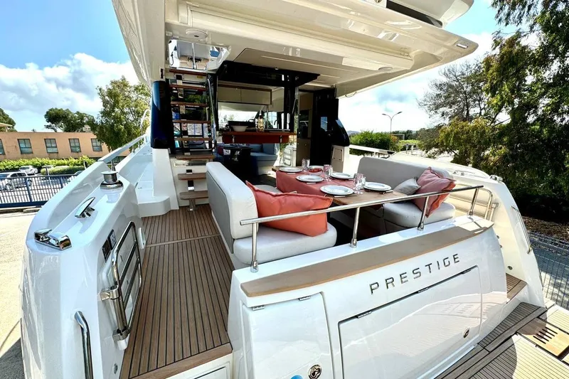  Yacht Photos Pics Luxurious 2026 Prestige F4.9 yacht with elegant outdoor dining area and modern design.
