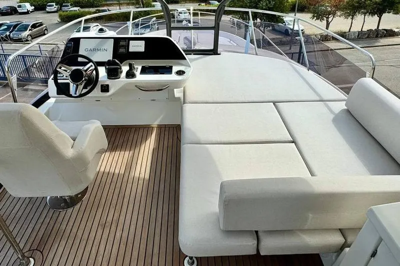  Yacht Photos Pics Luxurious 2026 Prestige F4.9 yacht interior with helm and seating area, featuring modern design.