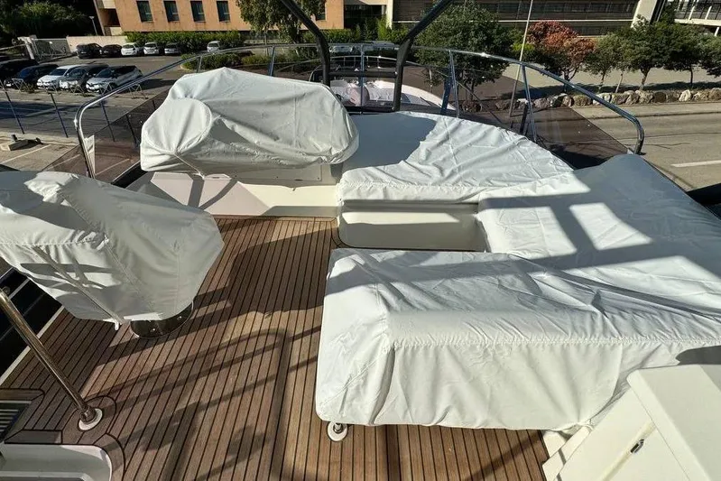  Yacht Photos Pics Luxurious 2026 Prestige F4.9 yacht deck with covered seating and scenic view.