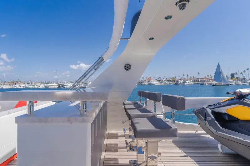 Gyrfalcon Yacht Photos Pics Flybridge seating area on 2016 Van der Valk 78 Flybridge Motor Yacht, docked in a marina.