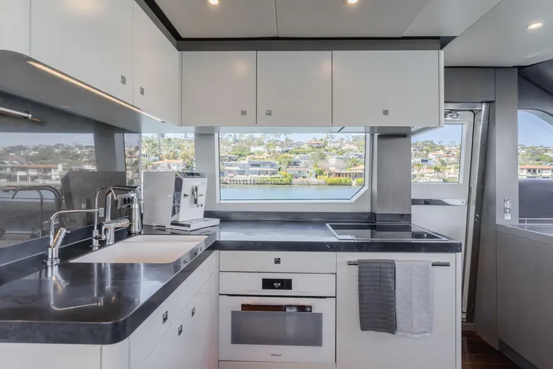 Gyrfalcon Yacht Photos Pics Modern kitchen in 2016 Van der Valk 78 Flybridge Motor Yacht with sleek countertops and appliances.