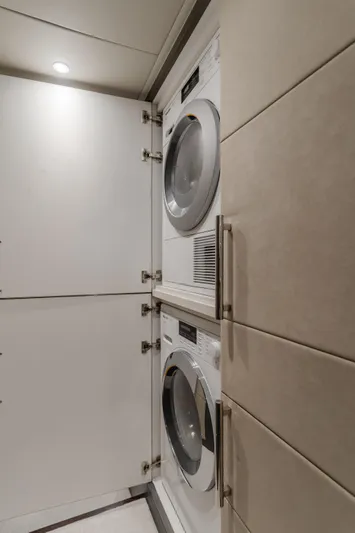 Gyrfalcon Yacht Photos Pics Laundry area with stacked washer and dryer in 2016 Van der Valk 78 Flybridge Motor Yacht.