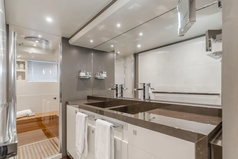 Gyrfalcon Yacht Photos Pics Luxurious bathroom in 2016 Van der Valk 78 Flybridge Motor Yacht with double sinks and modern fixtures.