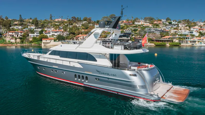 Gyrfalcon Yacht Photos Pics 2016 Van der Valk 78 Flybridge Motor Yacht cruising near coastal homes.