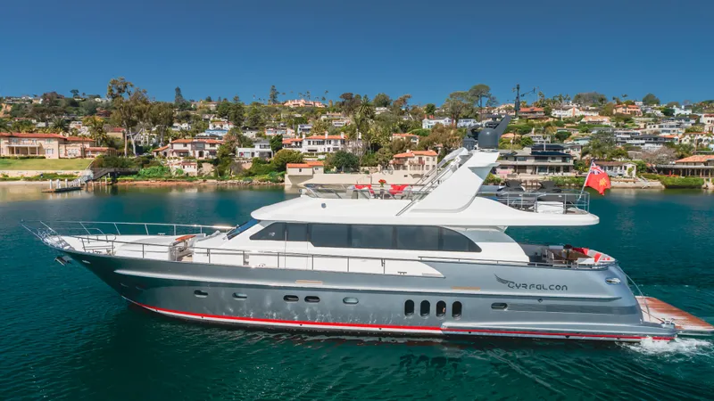 Gyrfalcon Yacht Photos Pics 2016 Van der Valk 78 Flybridge Motor Yacht cruising near a coastal town.