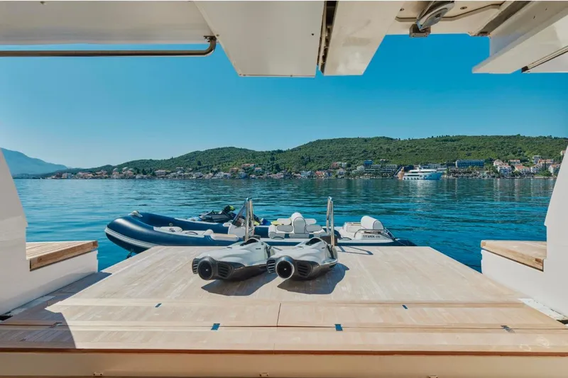 Sanlorenzo Sl118 Yacht Photos Pics Sanlorenzo SL118 yacht deck with water toys, overlooking serene coastal landscape.