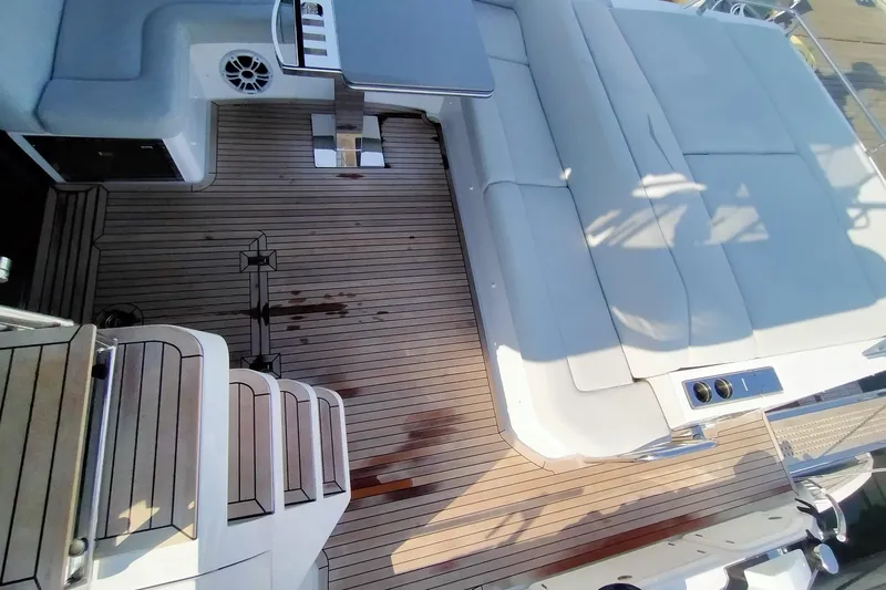  Yacht Photos Pics 2023 Azimut S6 Sportfly yacht deck with luxurious seating and wooden flooring.