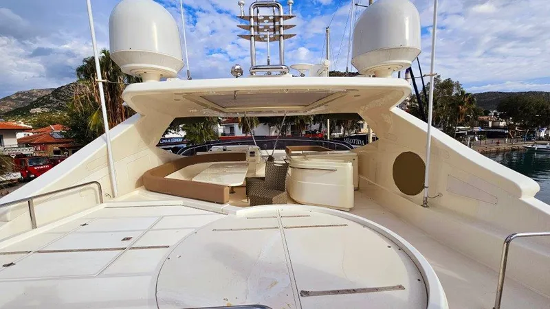  Yacht Photos Pics Luxurious 2012 Ferretti Yachts 881 deck with seating and radar domes, docked in a scenic marina.