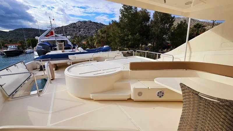  Yacht Photos Pics Luxurious 2012 Ferretti Yachts 881 deck with seating, docked near scenic landscape.