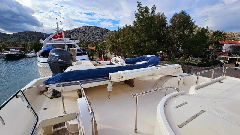  Yacht Photos Pics 2012 Ferretti Yachts 881 on deck, featuring a small boat and scenic marina backdrop.