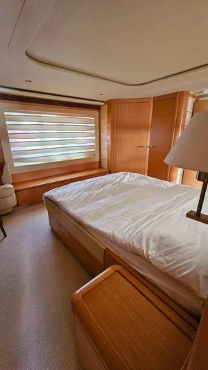  Yacht Photos Pics Luxurious bedroom interior of 2012 Ferretti Yachts 881 with wooden furnishings.
