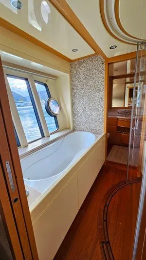  Yacht Photos Pics Luxurious bathroom with a bathtub and scenic window view on a 2012 Ferretti Yachts 881.