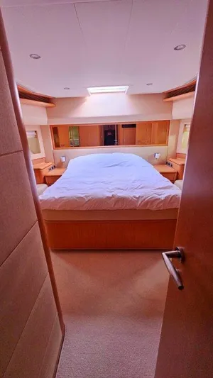  Yacht Photos Pics Luxurious bedroom interior of 2012 Ferretti Yachts 881, featuring a spacious bed and elegant wood finishes.