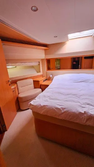  Yacht Photos Pics Luxurious bedroom interior of 2012 Ferretti Yachts 881 with cozy bed and seating area.