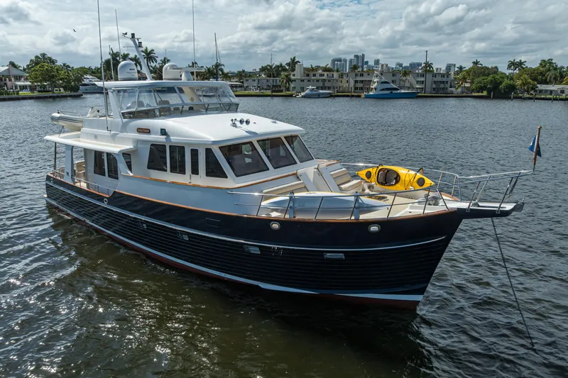 Monkey Business Yacht Photos Pics 2007 Grand Banks 59 Aleutian RP yacht on calm water, featuring a sleek design.
