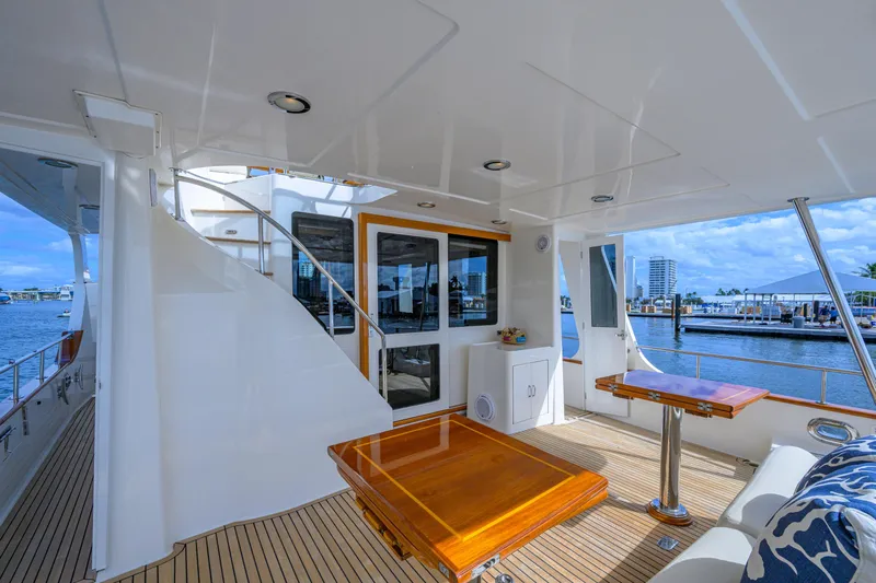 Monkey Business Yacht Photos Pics Luxurious 2007 Grand Banks 59 Aleutian RP yacht deck with elegant wood furnishings and waterfront view.