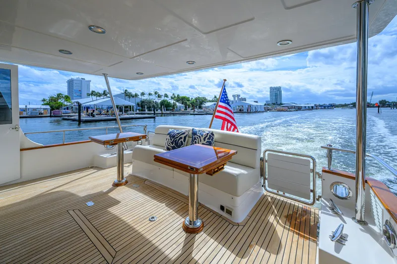 Monkey Business Yacht Photos Pics Luxurious 2007 Grand Banks 59 Aleutian RP yacht with elegant deck and waterfront view.