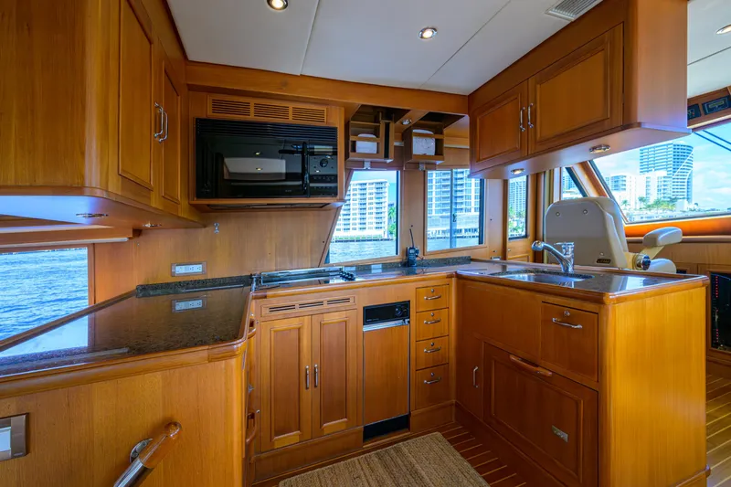 Monkey Business Yacht Photos Pics Luxurious 2007 Grand Banks 59 Aleutian RP yacht kitchen with wood cabinetry and modern appliances.