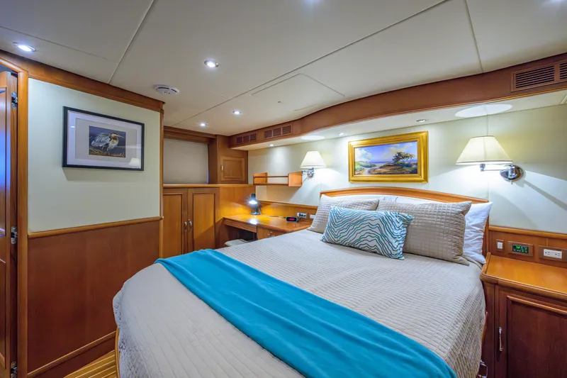 Monkey Business Yacht Photos Pics Luxurious 2007 Grand Banks 59 Aleutian RP yacht bedroom with elegant decor and cozy lighting.