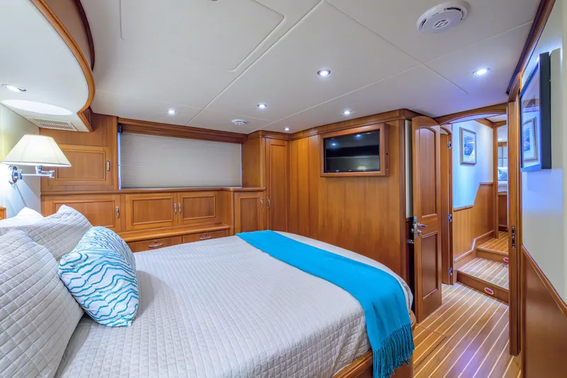 Monkey Business Yacht Photos Pics Luxurious cabin interior of 2007 Grand Banks 59 Aleutian RP yacht, featuring elegant wood finishes.