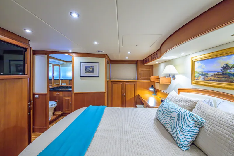 Monkey Business Yacht Photos Pics Luxurious 2007 Grand Banks 59 Aleutian RP yacht bedroom with elegant wood finishes.