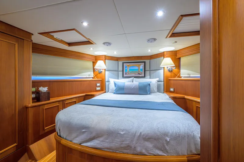 Monkey Business Yacht Photos Pics Luxurious 2007 Grand Banks 59 Aleutian RP yacht bedroom with elegant wood paneling.