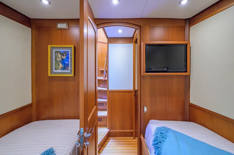 Monkey Business Yacht Photos Pics Luxurious 2007 Grand Banks 59 Aleutian RP yacht cabin with twin beds and TV.
