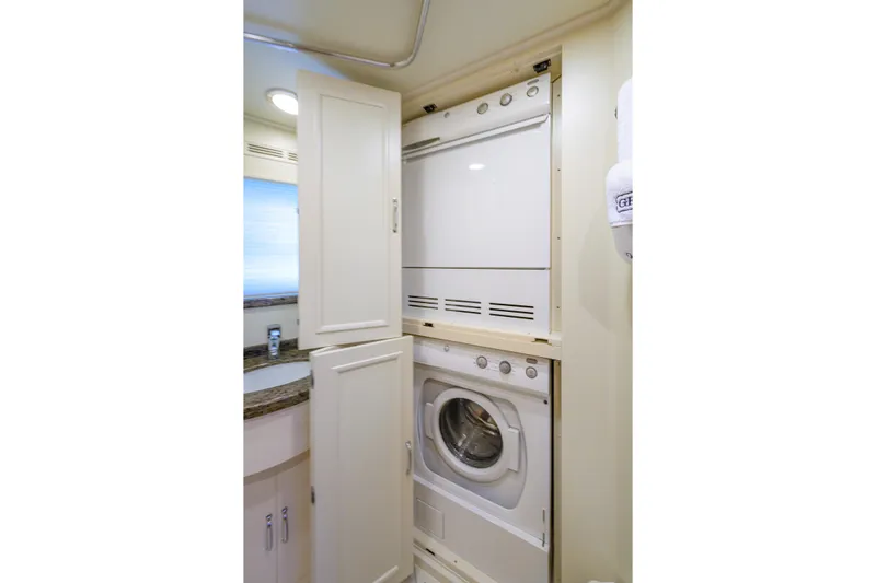 Monkey Business Yacht Photos Pics Laundry area with stacked washer and dryer in 2007 Grand Banks 59 Aleutian RP yacht.