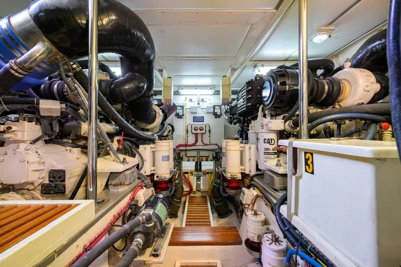 Monkey Business Yacht Photos Pics Engine room of 2007 Grand Banks 59 Aleutian RP yacht, featuring complex machinery and piping.