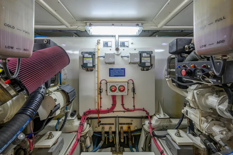 Monkey Business Yacht Photos Pics Engine room of 2007 Grand Banks 59 Aleutian RP yacht, featuring complex machinery and controls.
