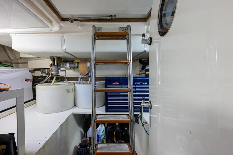 Monkey Business Yacht Photos Pics Engine room of 2007 Grand Banks 59 Aleutian RP with ladder and equipment.