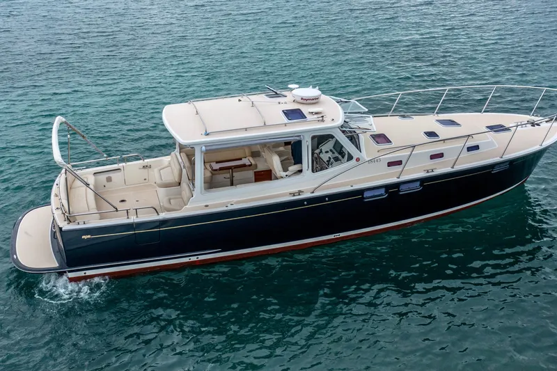 Handful Yacht Photos Pics 2014 MJM 40z yacht cruising on clear blue water.