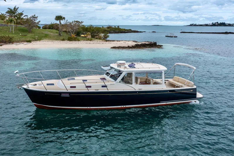 Handful Yacht Photos Pics 2014 MJM 40z yacht cruising near a tropical island with clear blue waters.