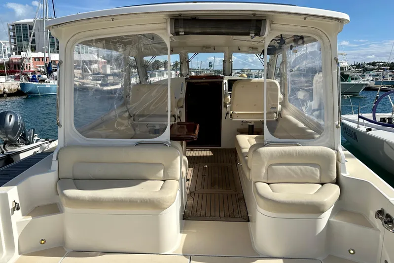 Handful Yacht Photos Pics 2014 MJM 40z yacht interior with beige seating, docked at a marina.