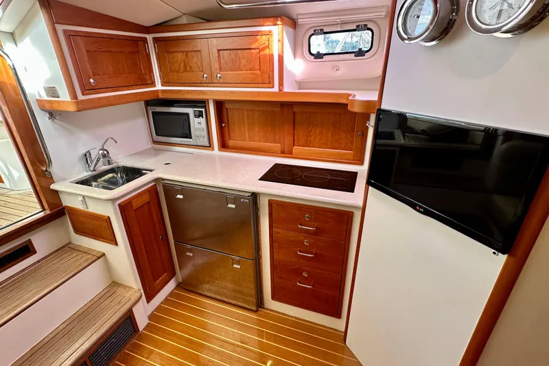 Handful Yacht Photos Pics Luxurious 2014 MJM 40z yacht kitchen with wood cabinetry, stainless appliances, and modern amenities.