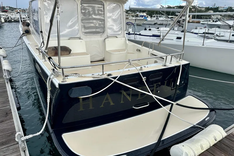 Handful Yacht Photos Pics 2014 MJM 40z yacht docked at marina, featuring spacious deck and elegant design.