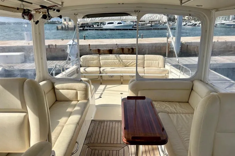 Handful Yacht Photos Pics Luxurious interior of a 2014 MJM 40z yacht with cream leather seating and wooden table.