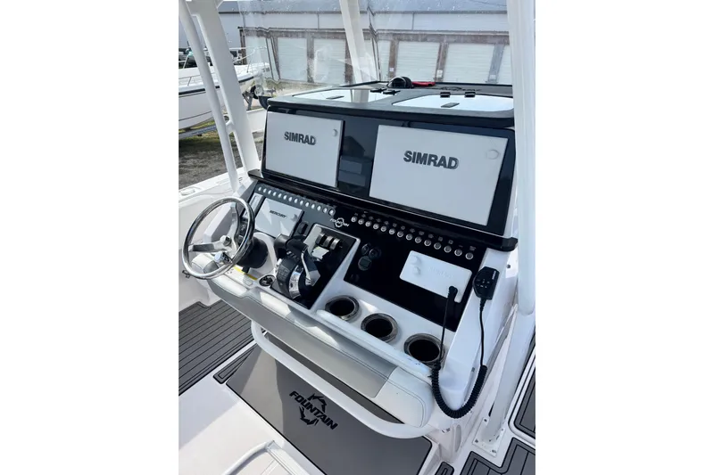  Yacht Photos Pics 2018 Fountain 34 Center Console boat dashboard with Simrad displays and steering wheel.