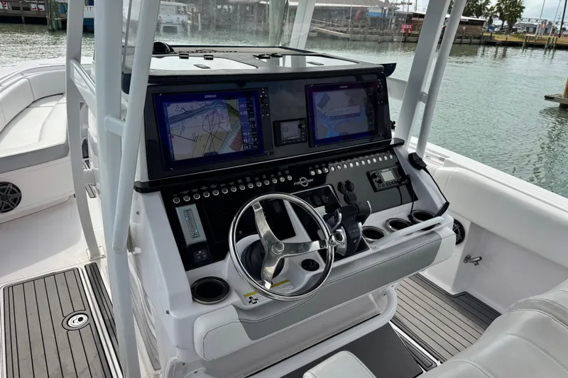  Yacht Photos Pics 2018 Fountain 34 Center Console boat with advanced navigation system and sleek steering wheel.