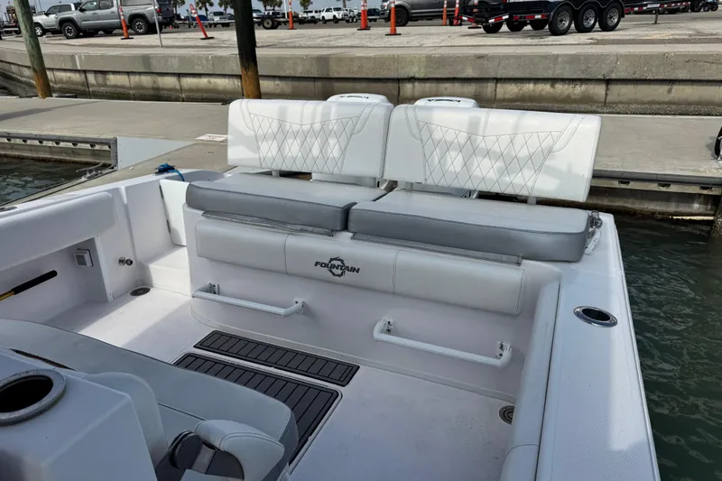  Yacht Photos Pics 2018 Fountain 34 Center Console boat interior with white seating at dock.