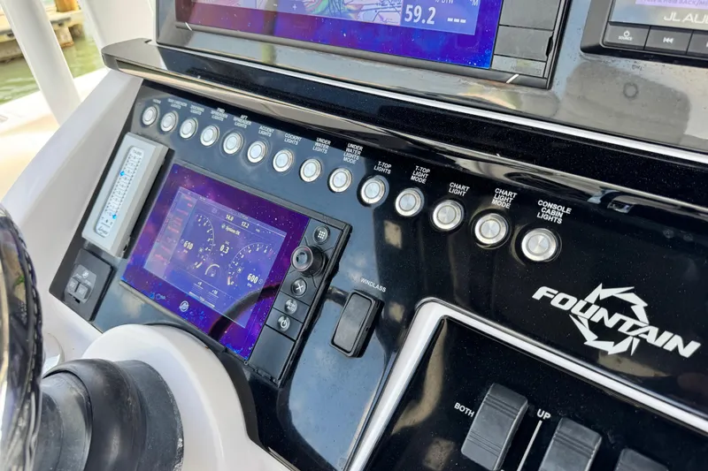  Yacht Photos Pics Control panel of a 2018 Fountain 34 Center Console boat with digital displays and switches.