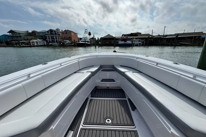 Yacht Photos Pics 2018 Fountain 34 Center Console boat docked, featuring spacious seating and sleek design.