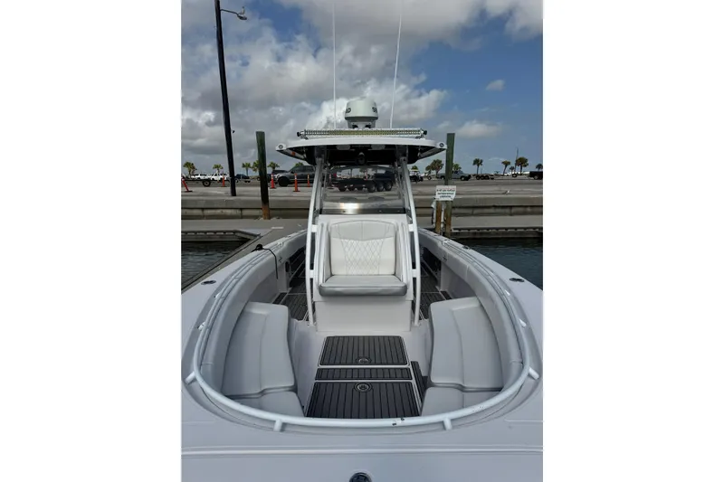  Yacht Photos Pics 2018 Fountain 34 Center Console boat docked, featuring sleek seating and modern design.