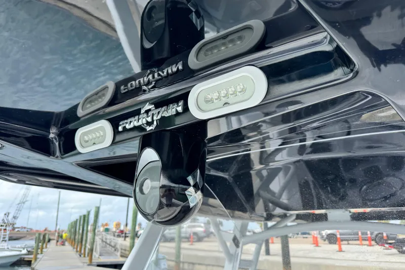  Yacht Photos Pics 2018 Fountain 34 Center Console boat detail with logo and dock background.