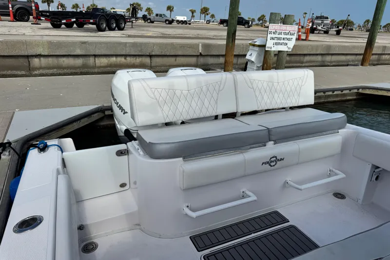  Yacht Photos Pics 2018 Fountain 34 Center Console boat interior with seating and dock view.